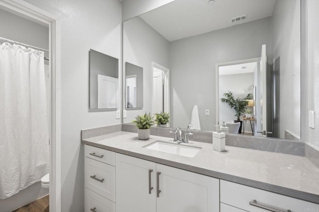1167 Via Lucero Oceanside, CA 92056 - Photo 24 of 54 a bathroom with a sink and a mirror