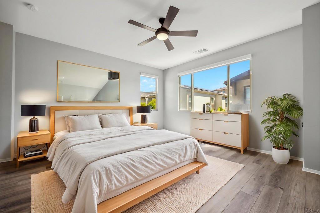 1167 Via Lucero Oceanside, CA 92056 - Photo 28 of 54 a bedroom with a bed potted plant with the outer view