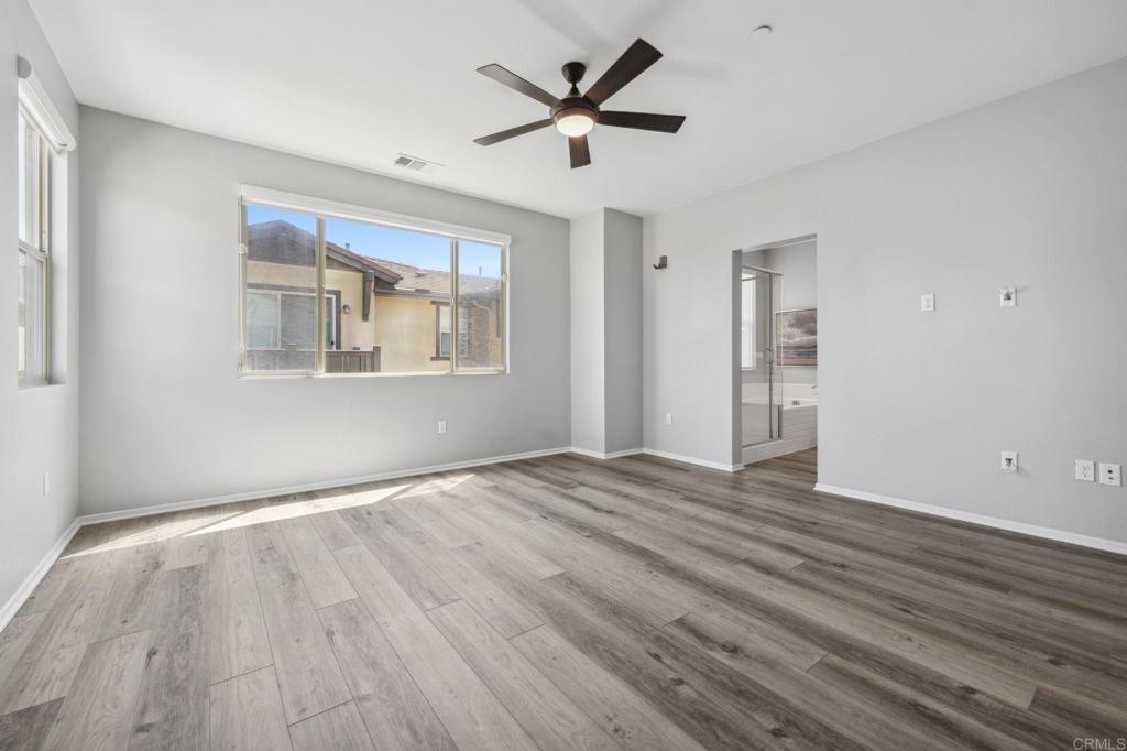 1167 Via Lucero Oceanside, CA 92056 - Photo 30 of 54 a view of an empty room with wooden floor and a window
