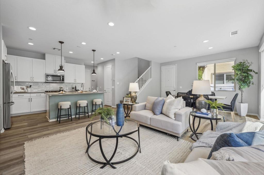 1167 Via Lucero Oceanside, CA 92056 - Photo 10 of 54 a living room with furniture and kitchen view