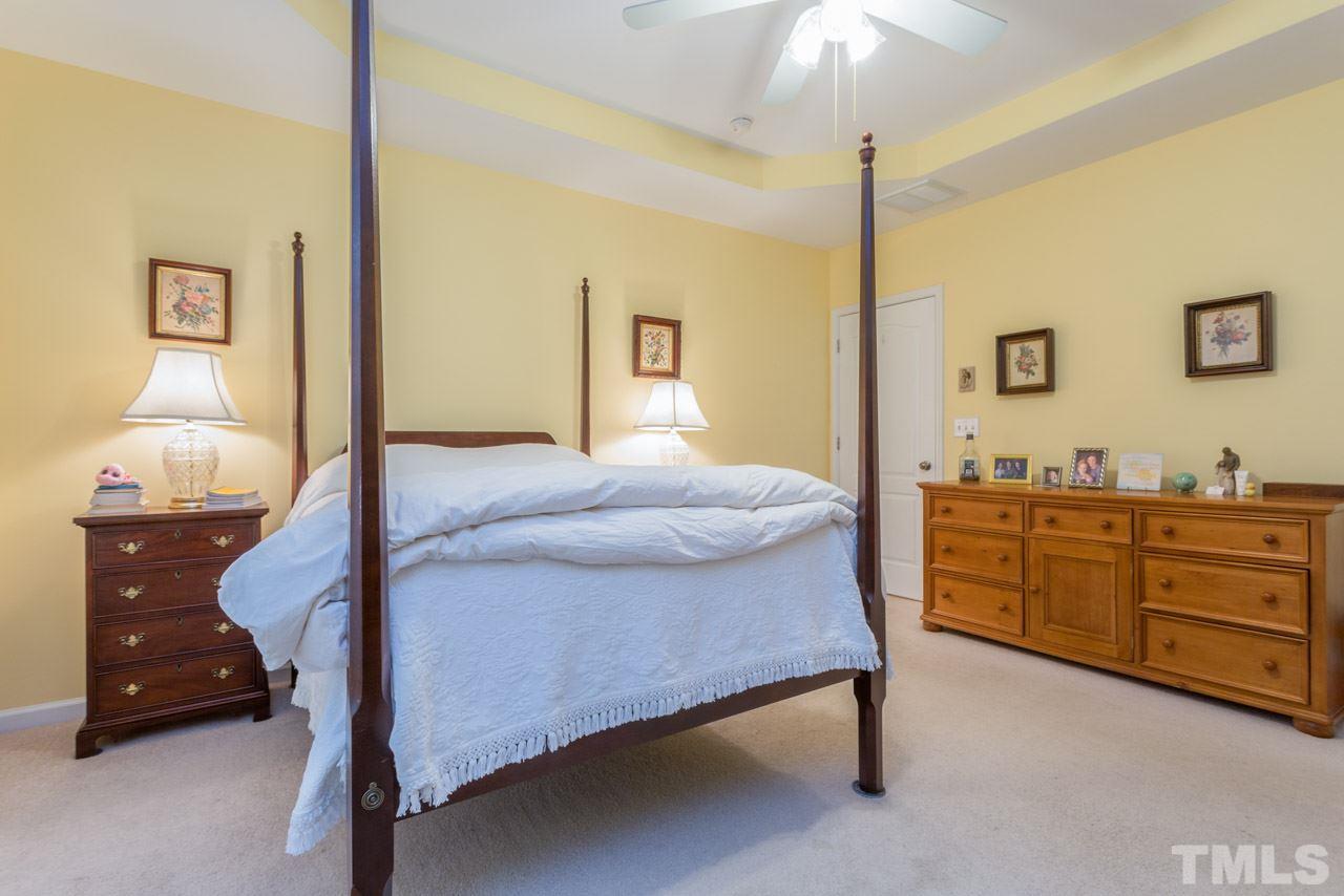 3406 Cathedral Bell Road Raleigh, NC 27614 - Photo 13 of 25 a bedroom with a bed and a dresser in it