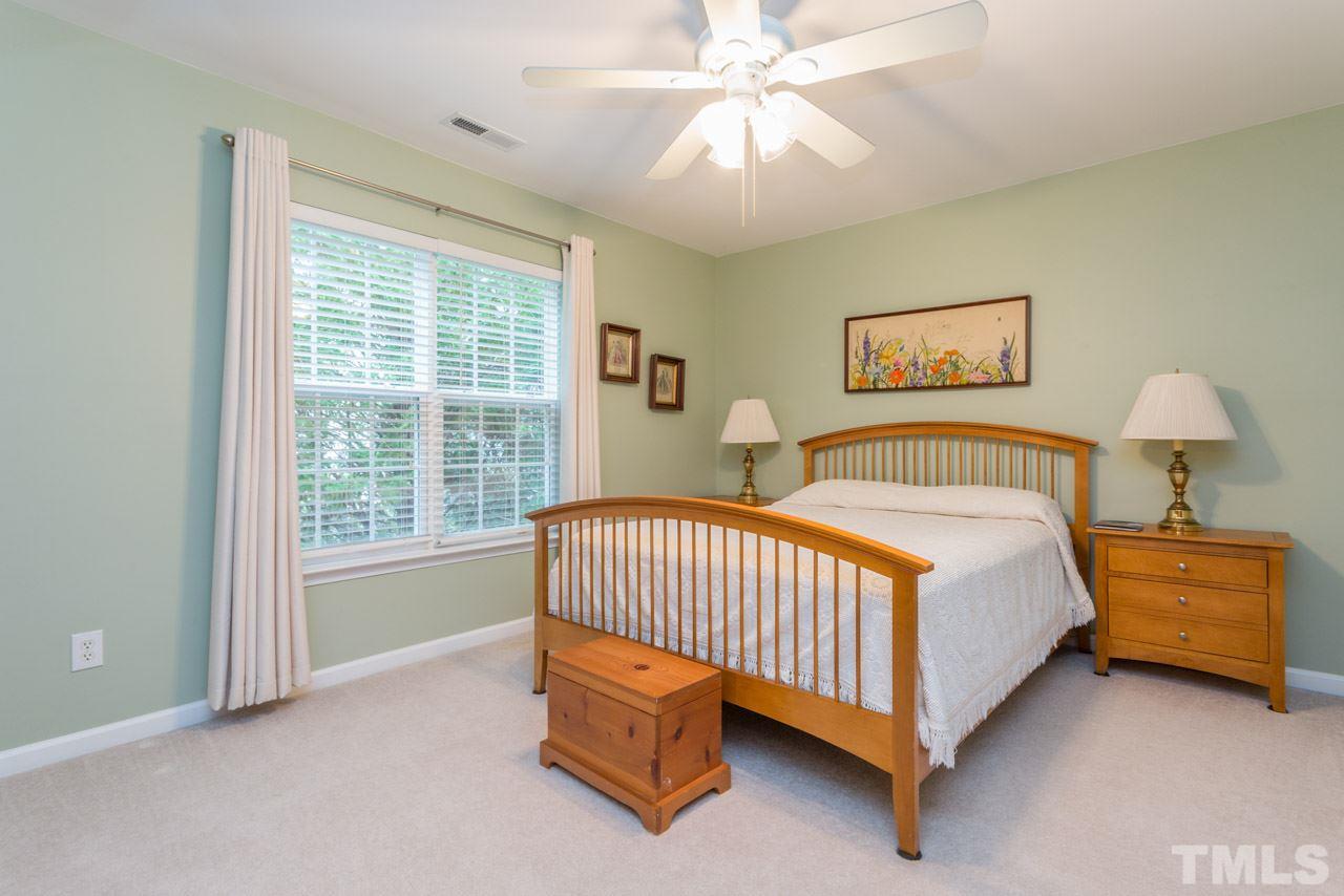 3406 Cathedral Bell Road Raleigh, NC 27614 - Photo 17 of 25 a spacious bedroom with a bed and a chandelier