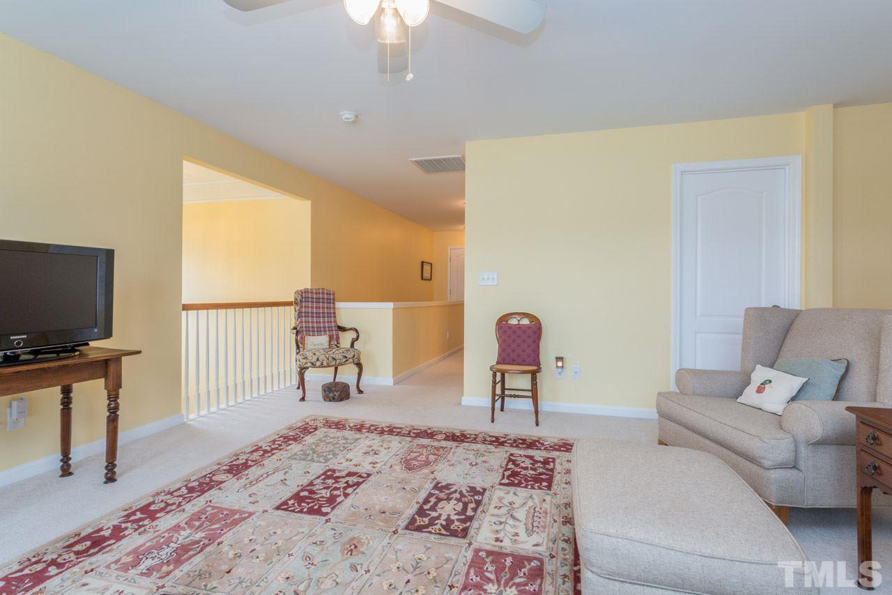 3406 Cathedral Bell Road Raleigh, NC 27614 - Photo 20 of 25 a living room with furniture and a flat screen tv