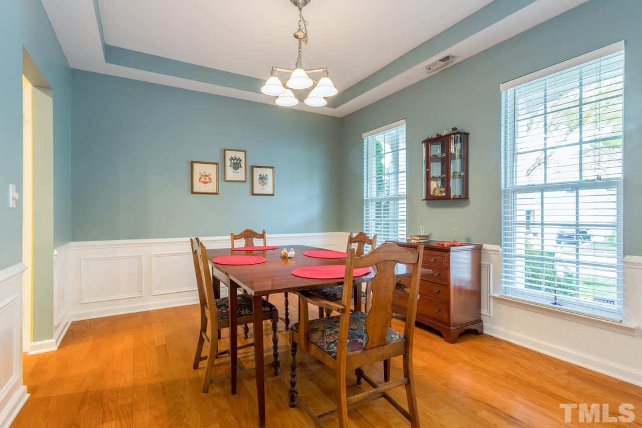 3406 Cathedral Bell Road Raleigh, NC 27614 - Photo 4 of 25 a dining room with a wooden table and chairs
