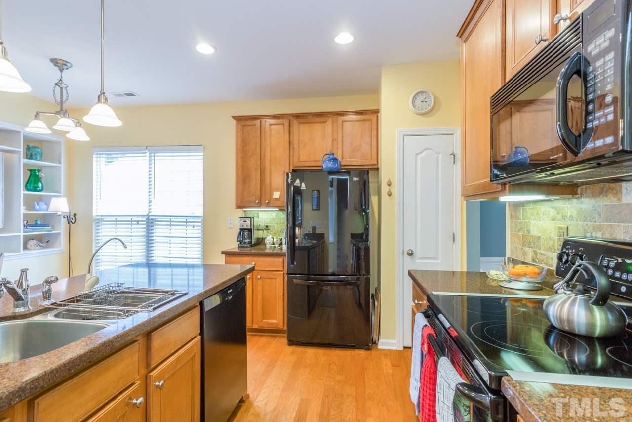 3406 Cathedral Bell Road Raleigh, NC 27614 - Photo 6 of 25 a kitchen with refrigerator a stove and a sink