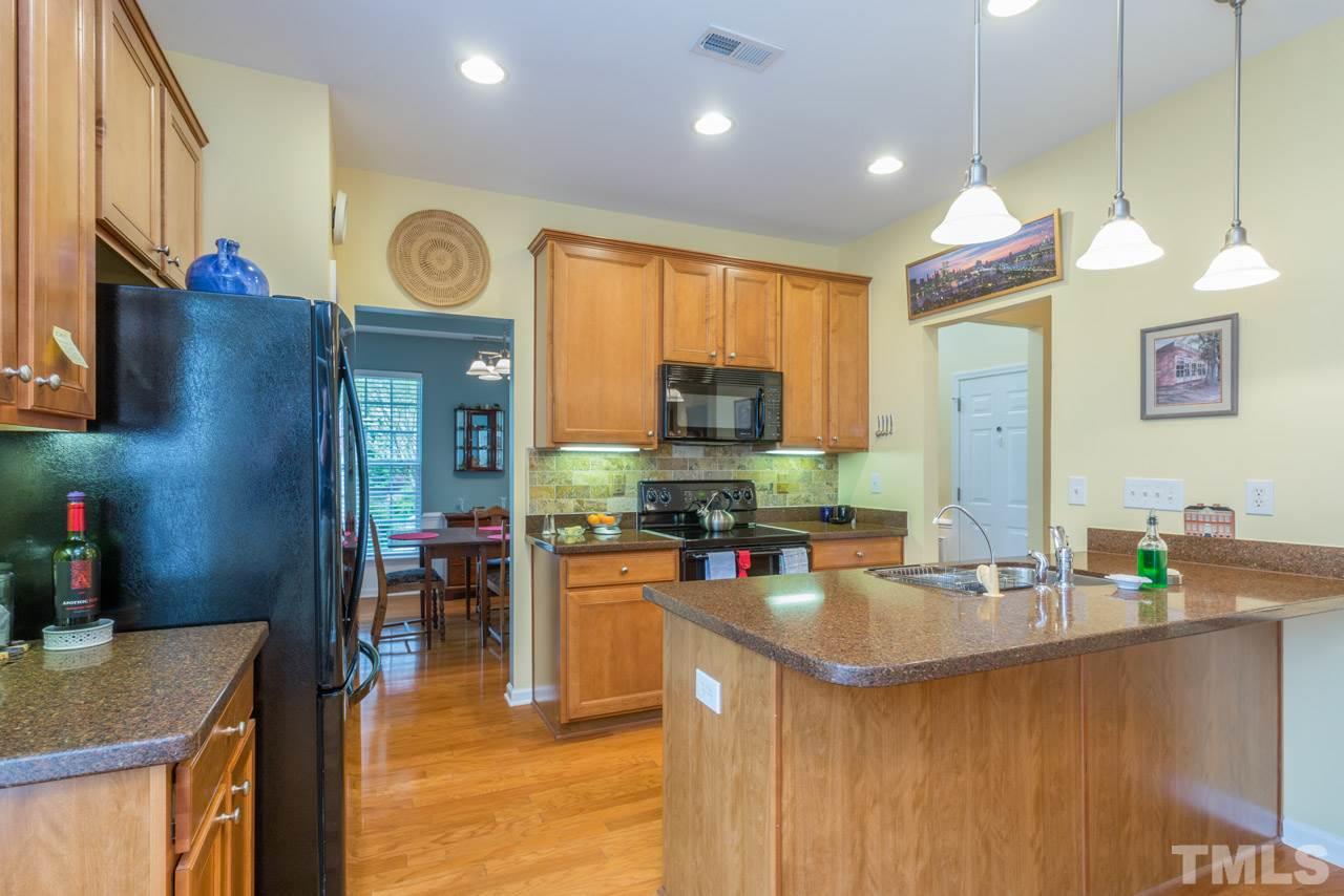 3406 Cathedral Bell Road Raleigh, NC 27614 - Photo 7 of 25 a kitchen that has a lot of cabinets a sink and a stove in it