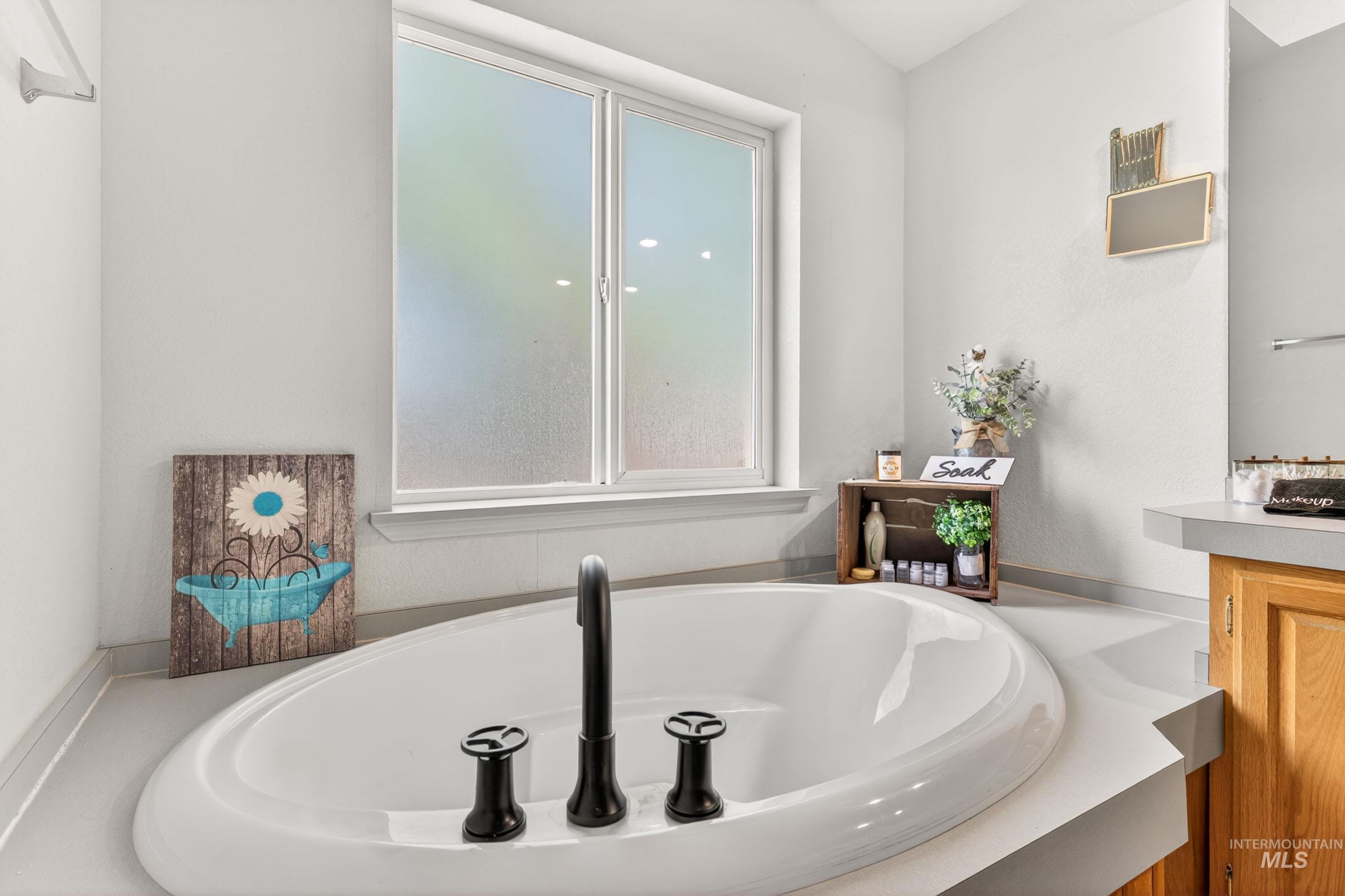 151 Cow Creek Road Lucile, ID 83542 - Photo 26 of 50 Built-in soaking tub with matte black fixtures, set into a light-toned surround