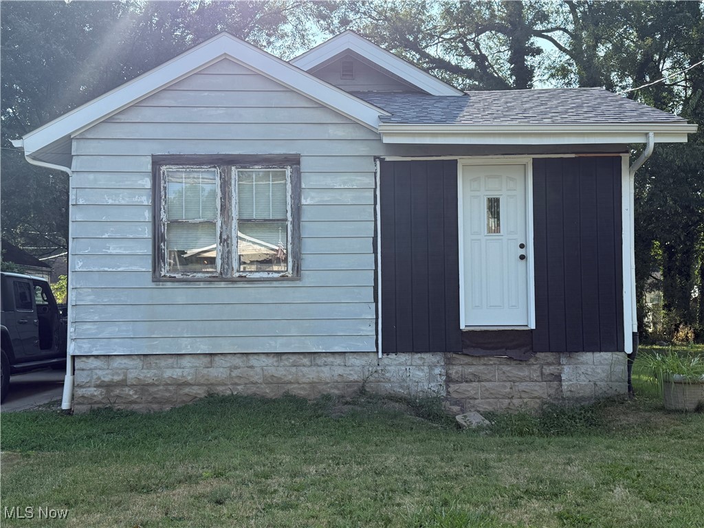 878 Brittain Road Akron, OH 44305 - Photo 1 of 16 View of front of house featuring a front yard and roof with shingles