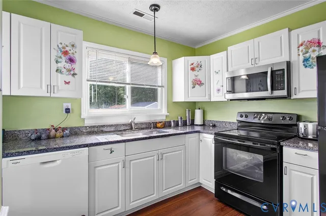 a kitchen with stainless steel appliances granite countertop a stove and a sink