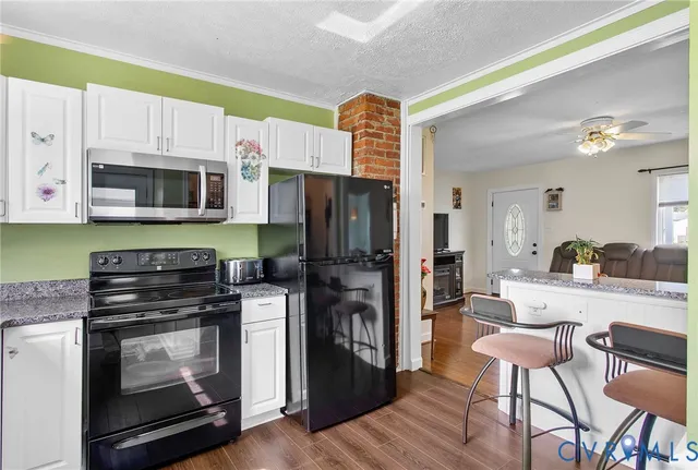 a kitchen with stainless steel appliances a stove microwave and refrigerator