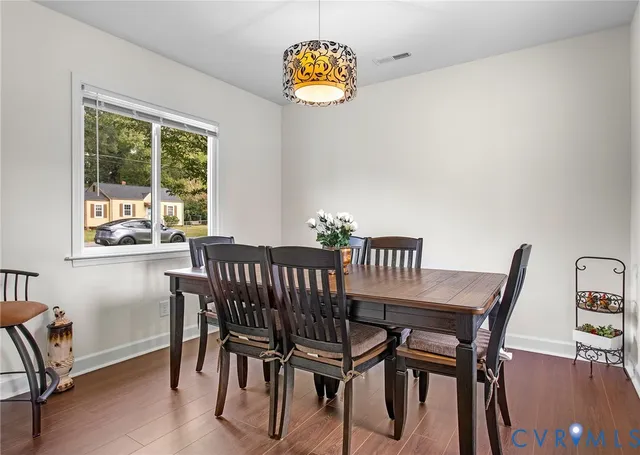 a view of a dining room with furniture window and wooden floor