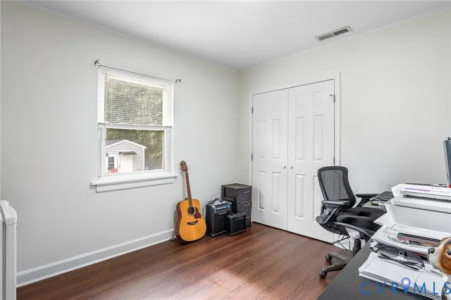 a view of workspace with wooden floor windows