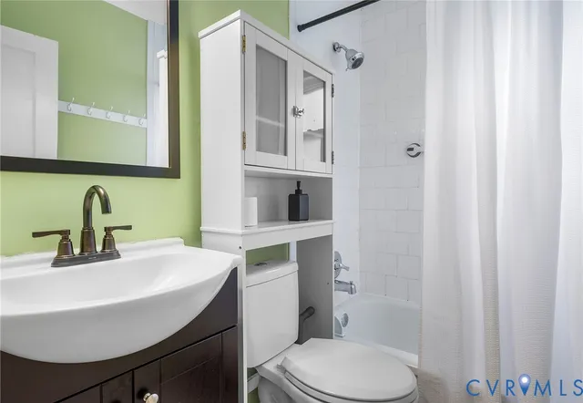 a bathroom with a sink toilet and mirror