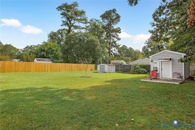 a view of a house with a yard and sitting area