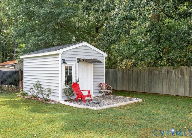 a view of a house with a yard and sitting area