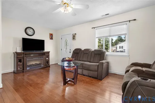 a living room with furniture and a flat screen tv