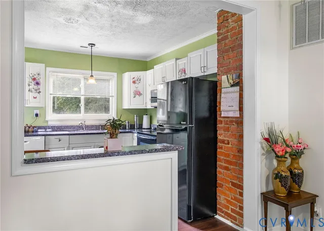a kitchen with stainless steel appliances a sink and a refrigerator