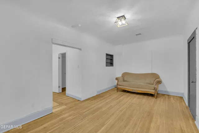 a bedroom with a bed and a wooden floor