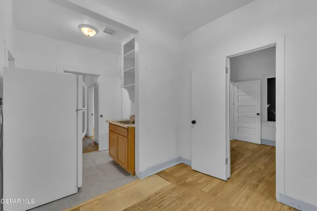 a view of a kitchen with wooden floor and a sink