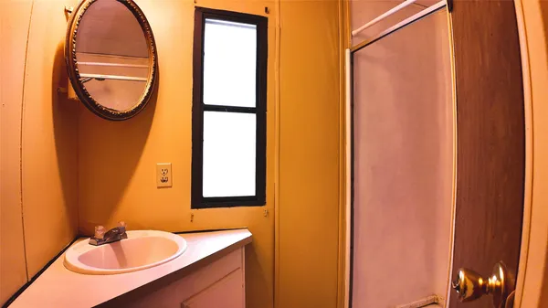 a view of a bathroom from a hallway