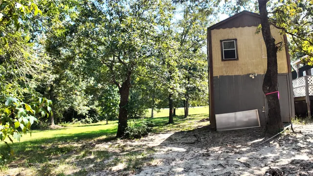 a view of a kitchen with wooden floor and a window