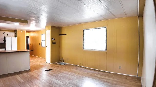 a view of kitchen with wooden floor and electronic appliances