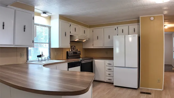 a kitchen with a sink and cabinets