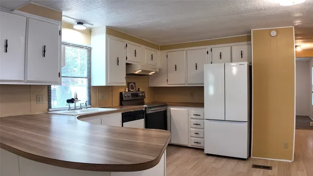 a kitchen with a sink and cabinets