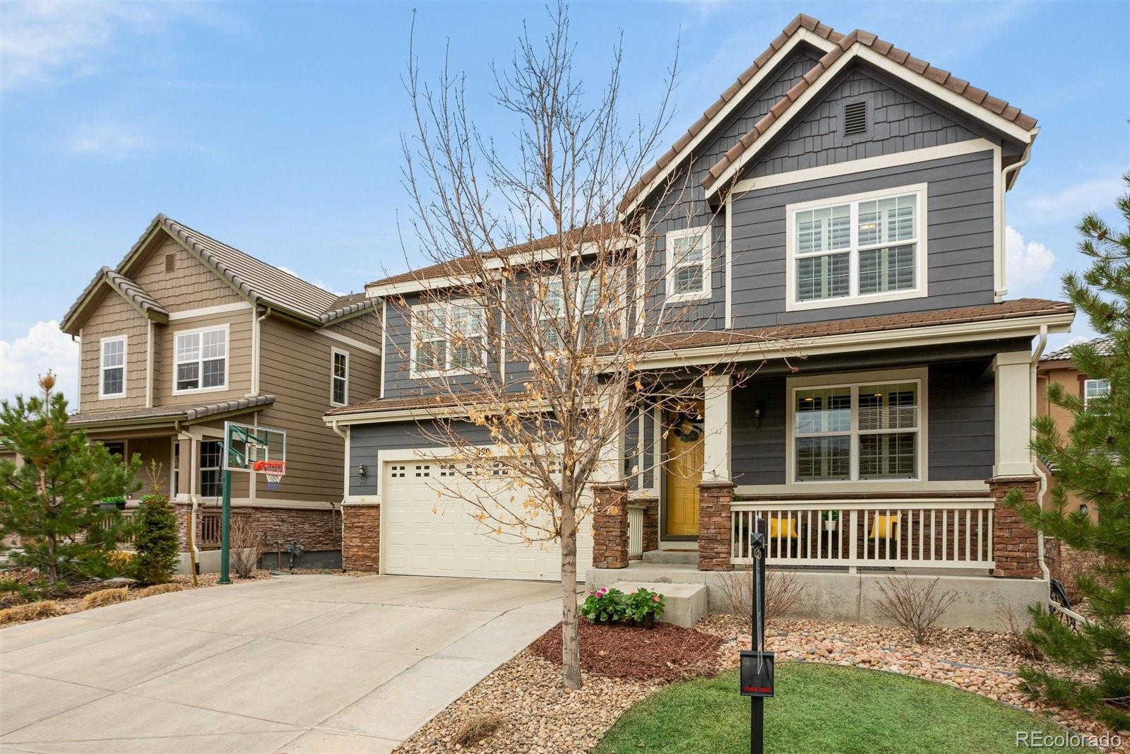 690 Tiger Lily Way Highlands Ranch, CO 80126 - Photo 1 of 38 a front view of a house with a yard
