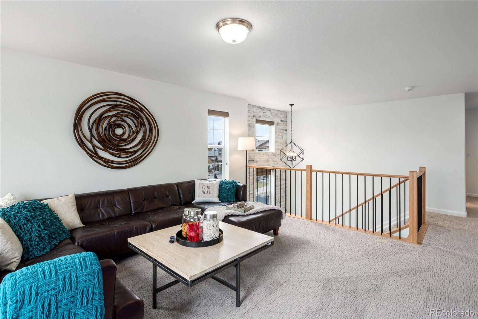 690 Tiger Lily Way Highlands Ranch, CO 80126 - Photo 13 of 38 a living room with furniture and a wooden floor