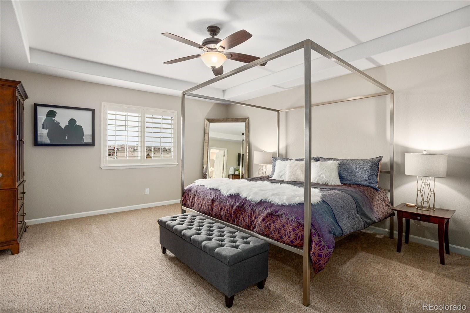 690 Tiger Lily Way Highlands Ranch, CO 80126 - Photo 14 of 38 a bedroom with a bed chandelier and window