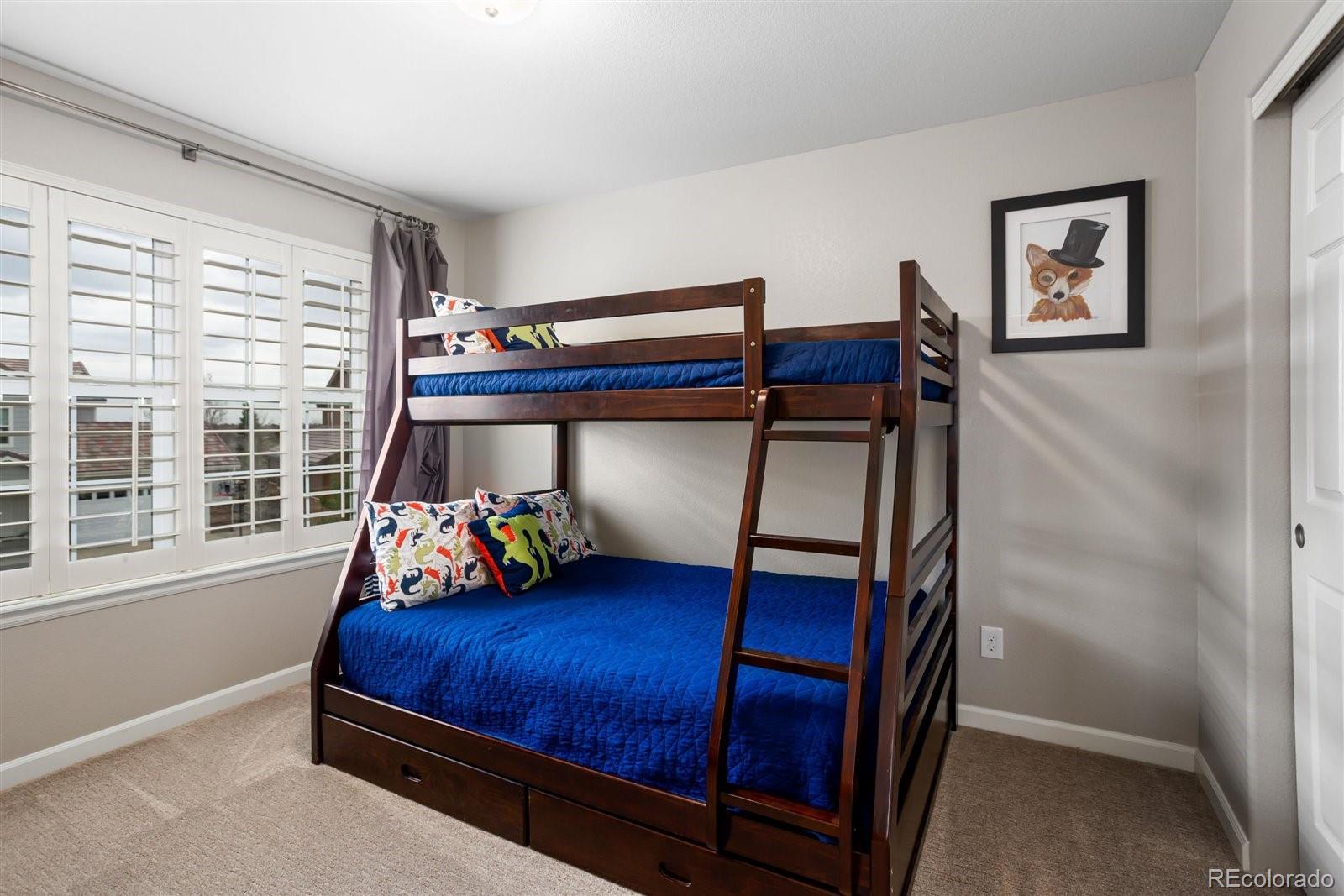 690 Tiger Lily Way Highlands Ranch, CO 80126 - Photo 18 of 38 a bedroom with a bed and a window
