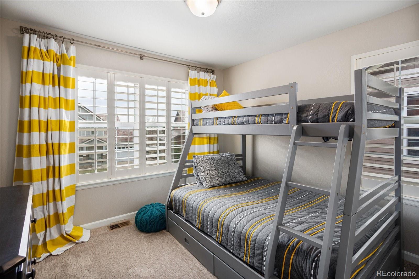 690 Tiger Lily Way Highlands Ranch, CO 80126 - Photo 20 of 38 a bedroom with a bed and a window