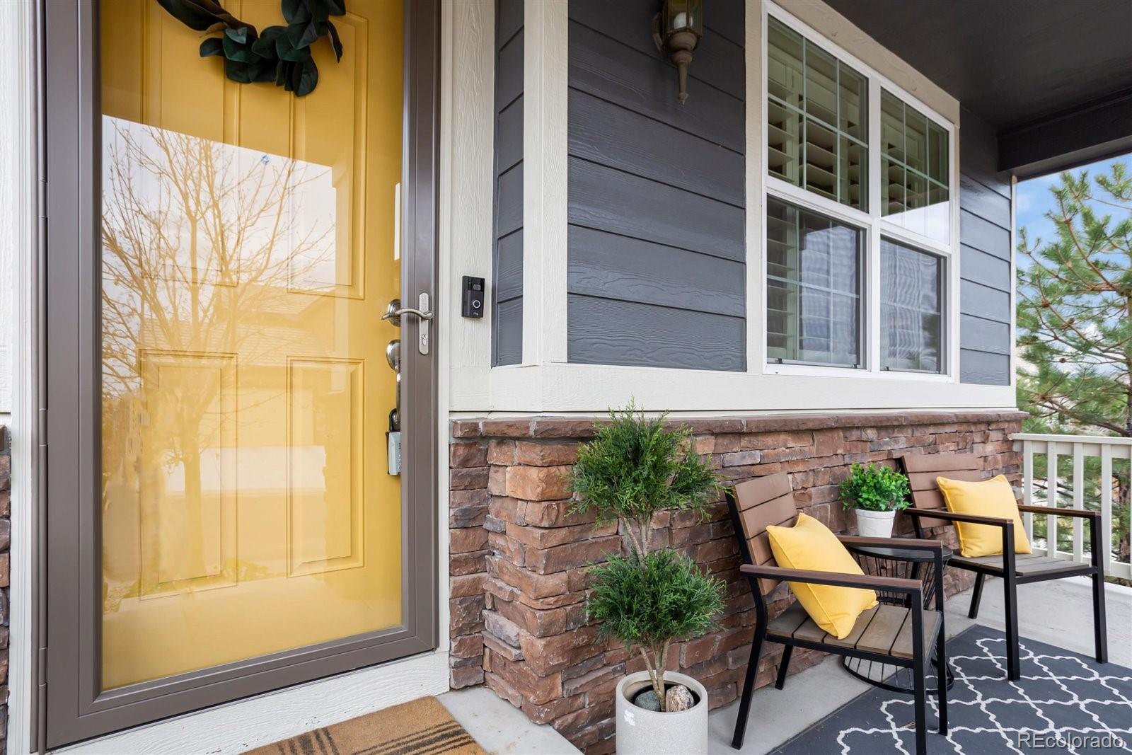 690 Tiger Lily Way Highlands Ranch, CO 80126 - Photo 2 of 38 a view of a balcony with table and chairs and potted plants