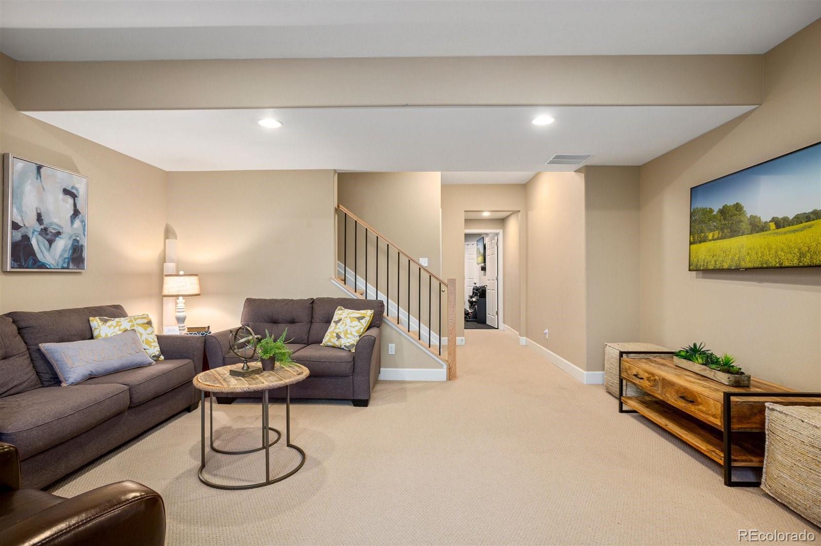 690 Tiger Lily Way Highlands Ranch, CO 80126 - Photo 23 of 38 a living room with furniture and a dining table with wooden floor