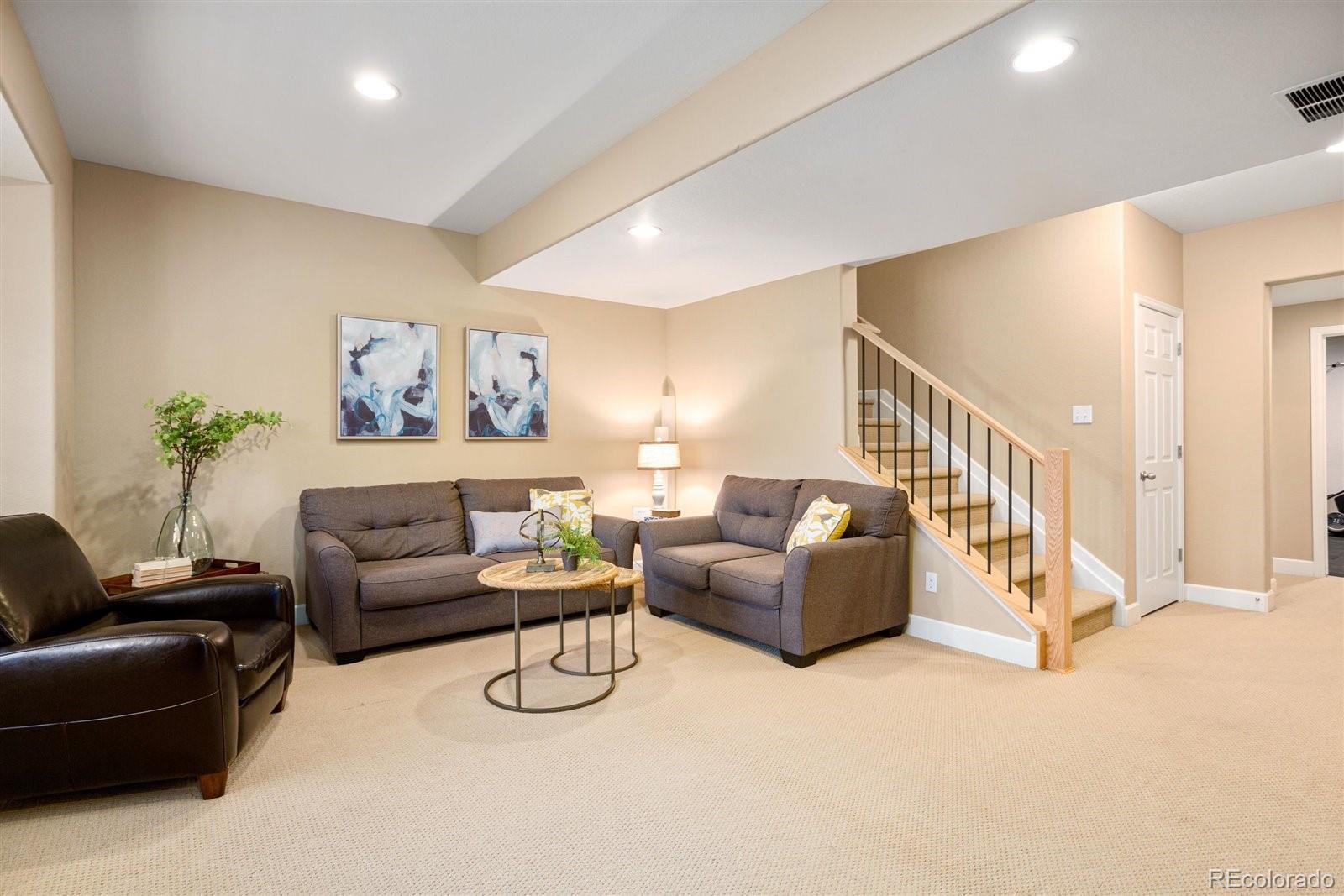 690 Tiger Lily Way Highlands Ranch, CO 80126 - Photo 24 of 38 a living room with furniture and a couch