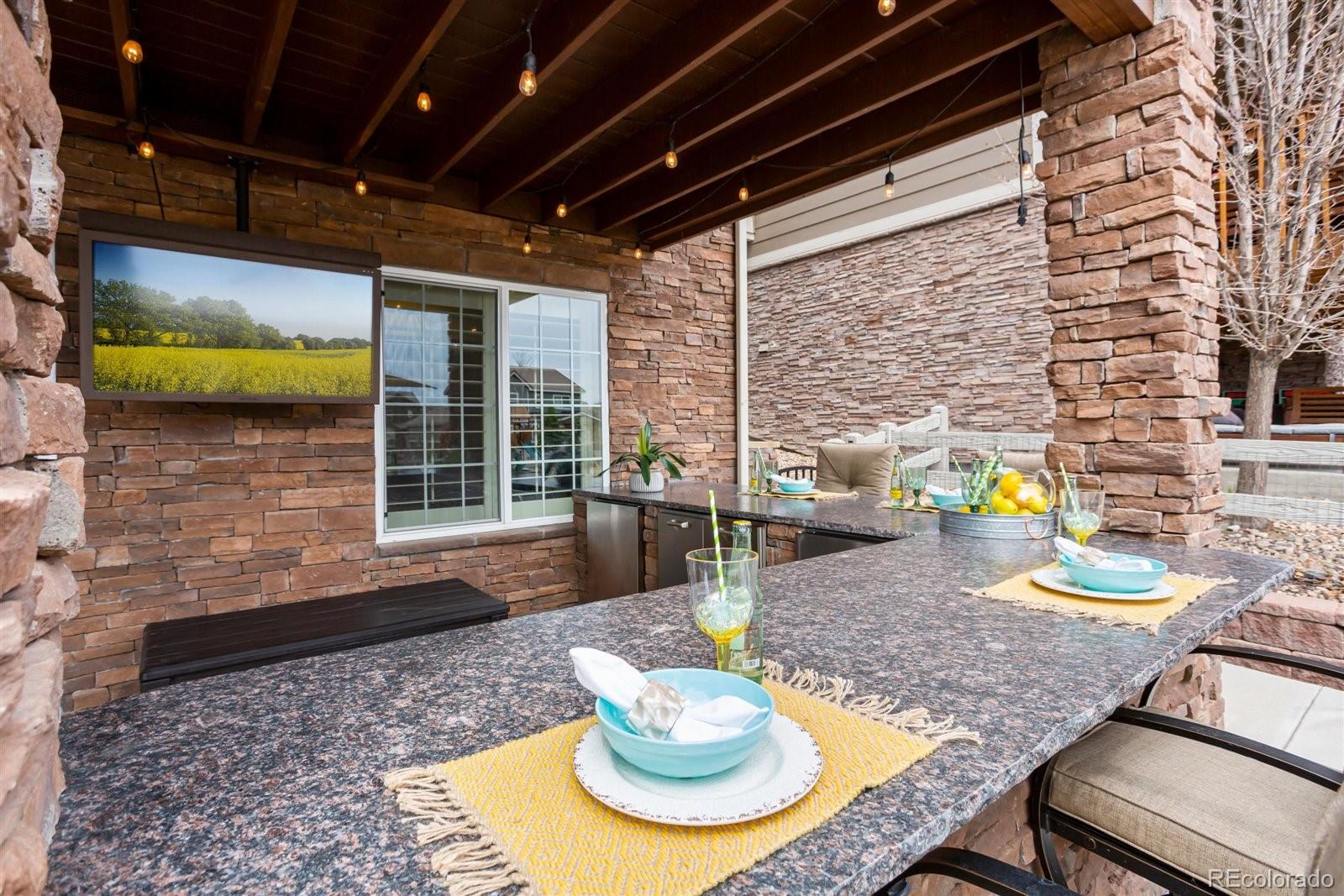 690 Tiger Lily Way Highlands Ranch, CO 80126 - Photo 28 of 38 a view of a dining room with a table and chairs