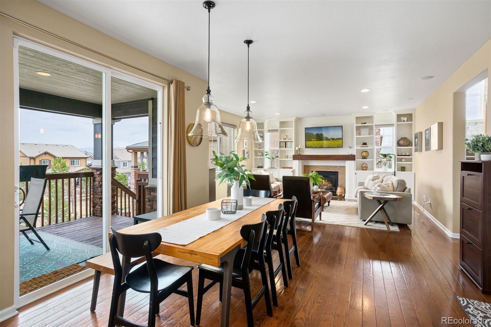 690 Tiger Lily Way Highlands Ranch, CO 80126 - Photo 7 of 38 a view of a dining room with furniture window and wooden floor
