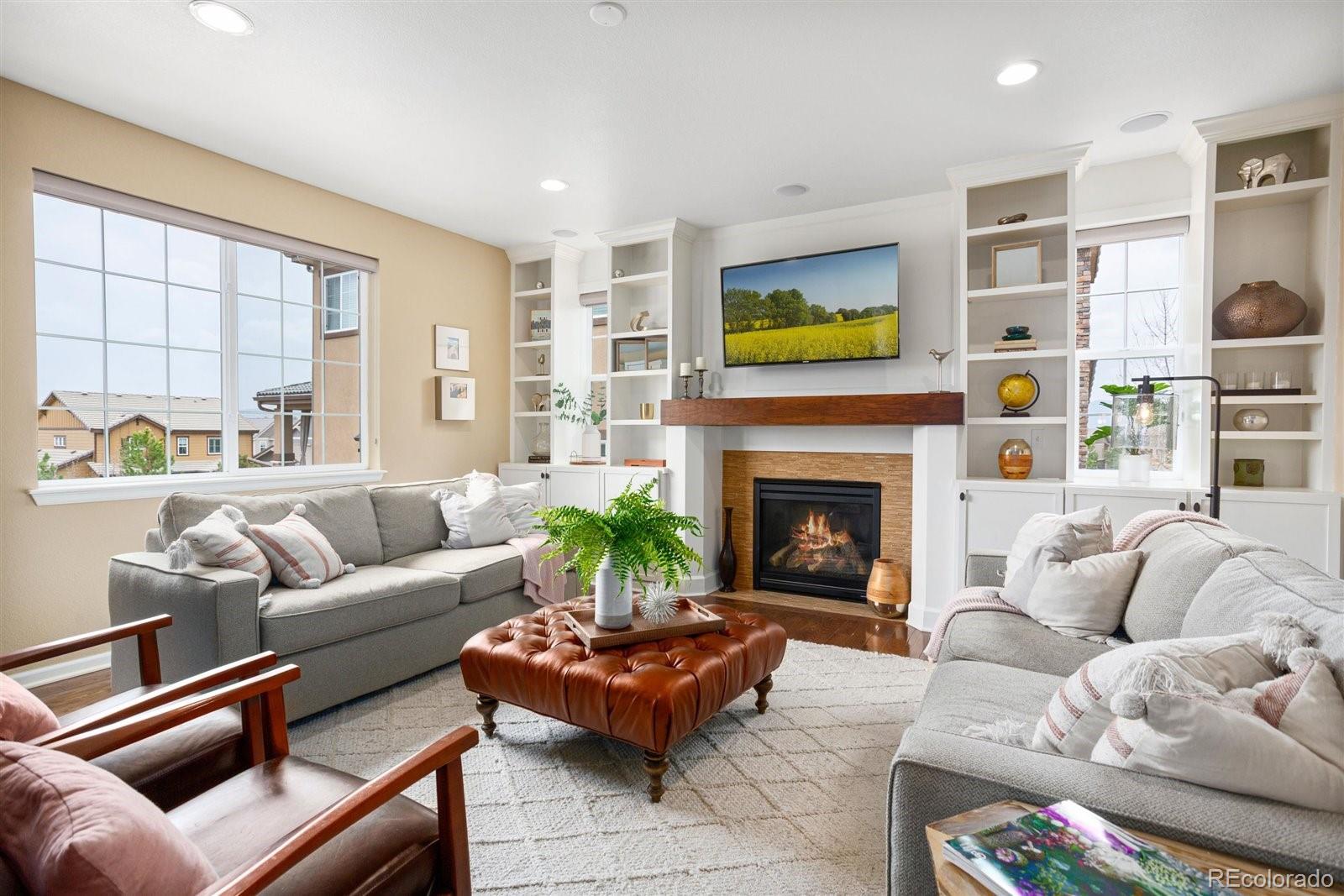 690 Tiger Lily Way Highlands Ranch, CO 80126 - Photo 9 of 38 a living room with furniture and a fireplace