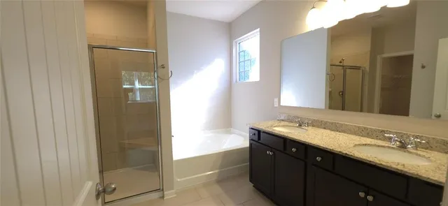 a bathroom with a granite countertop sink shower and a mirror