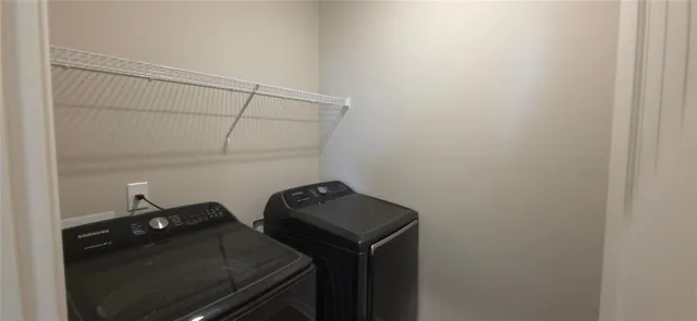 a view of storage and utility room with racks on the wall