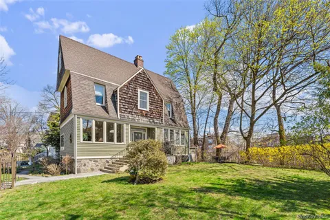 a front view of house with a garden