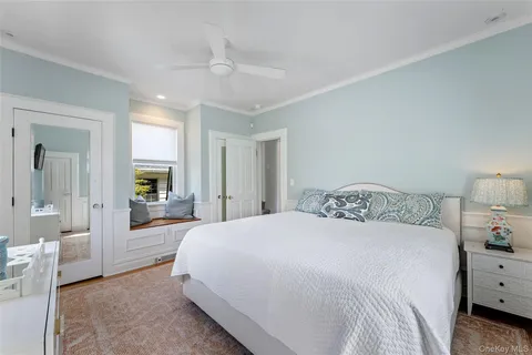 a spacious bedroom with a bed and a large mirror