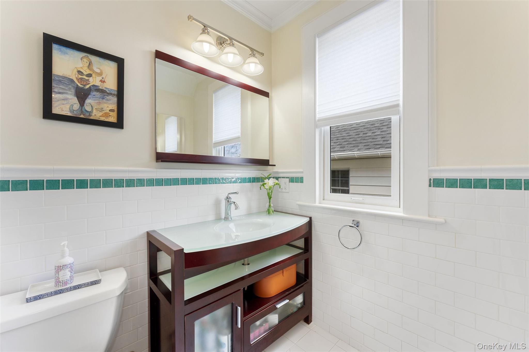 25 Merriam Avenue Bronxville, NY 10708 - Photo 13 of 26 a bathroom with a sink a toilet and mirror