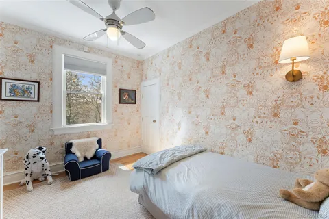 a bedroom with a bed couch and window