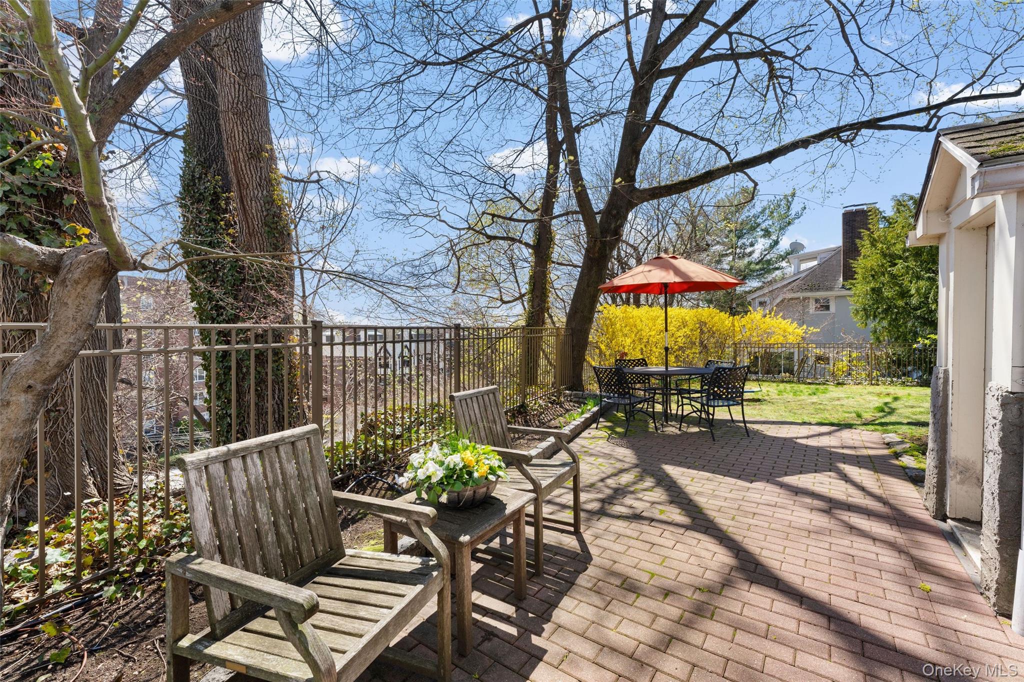 25 Merriam Avenue Bronxville, NY 10708 - Photo 19 of 26 a view of a chairs and table in backyard