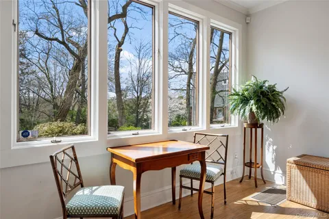 a view of a room with a large window and furniture