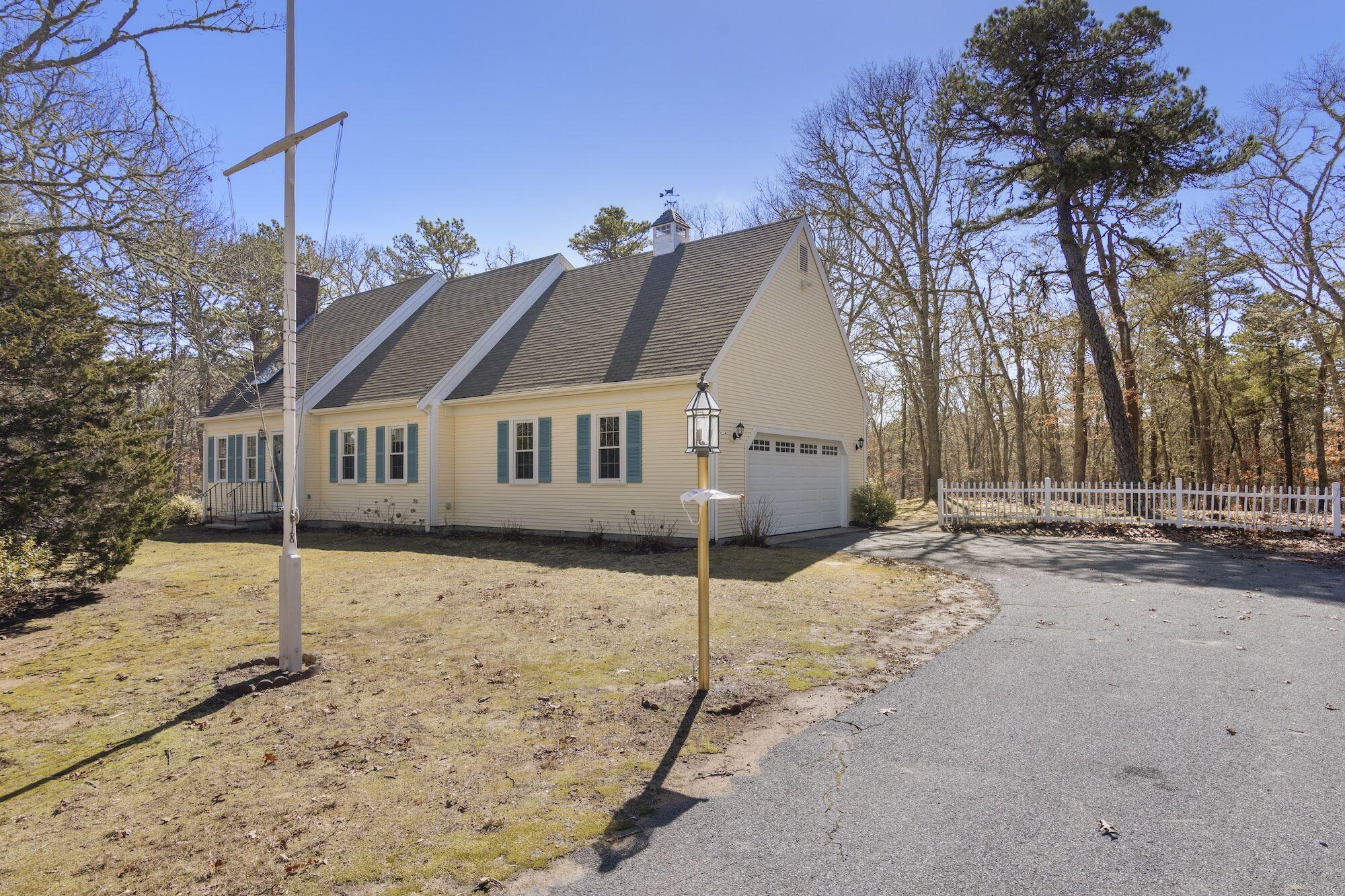 a front view of a house with a yard covered in snow