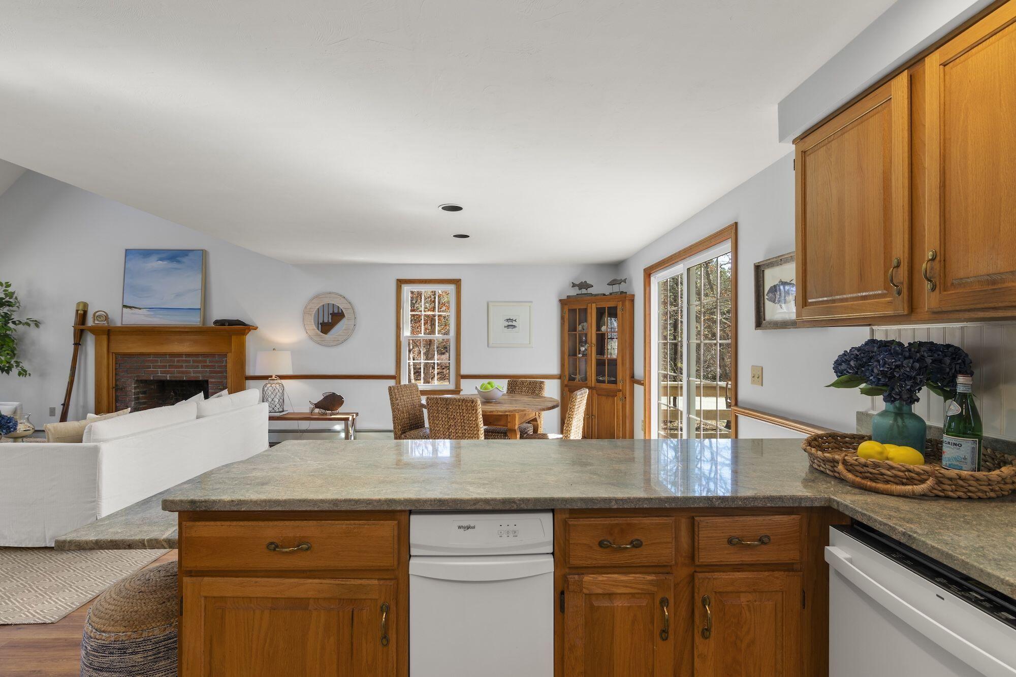 263 Spruce Road Harwich, MA 02645 - Photo 15 of 53 a kitchen with granite countertop a sink a stove and cabinets