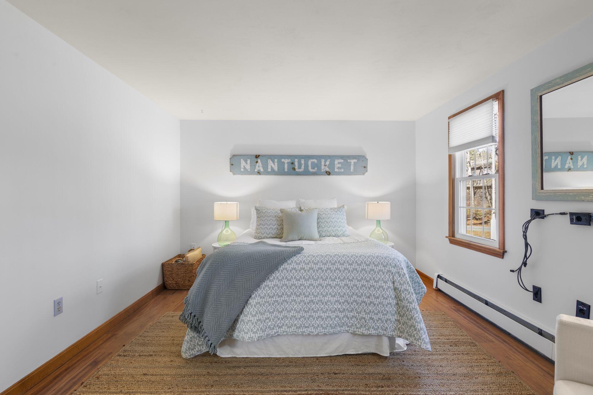 263 Spruce Road Harwich, MA 02645 - Photo 17 of 53 a bedroom with a bed and wooden floor